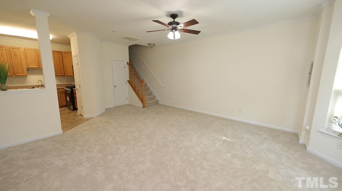 11710 Coppergate Drive, Unit 109 Raleigh, NC 27614 - Photo 4 of 15 an empty room with a ceiling fan and a window