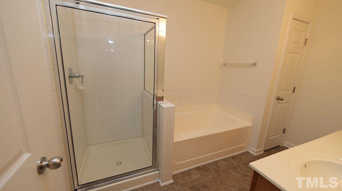 11710 Coppergate Drive, Unit 109 Raleigh, NC 27614 - Photo 9 of 15 a bathroom with a shower and sink