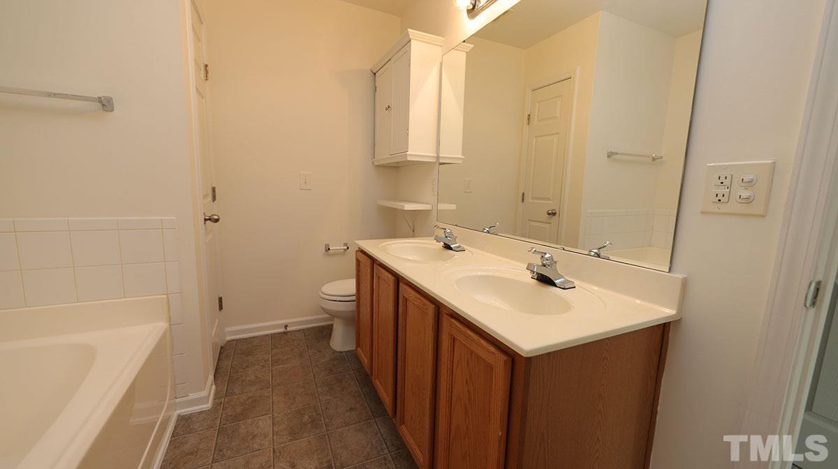 11710 Coppergate Drive, Unit 109 Raleigh, NC 27614 - Photo 10 of 15 a bathroom with a sink toilet and shower