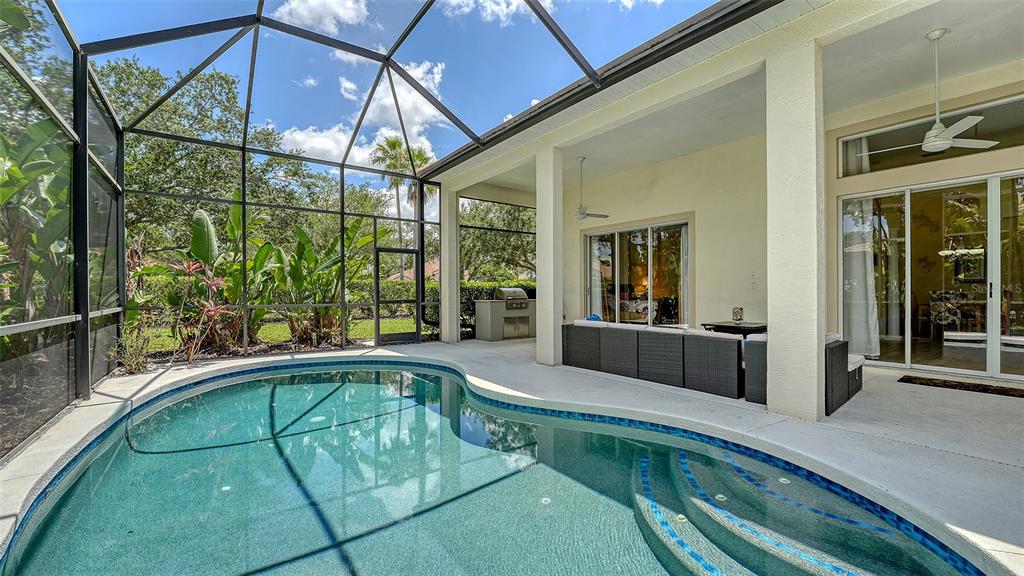 7717 US Open Loop Lakewood Ranch, FL 34202 - Photo 36 of 95 a swimming pool with large glass windows and painted walls