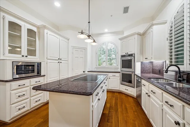 a kitchen with stainless steel appliances granite countertop a stove and a sink