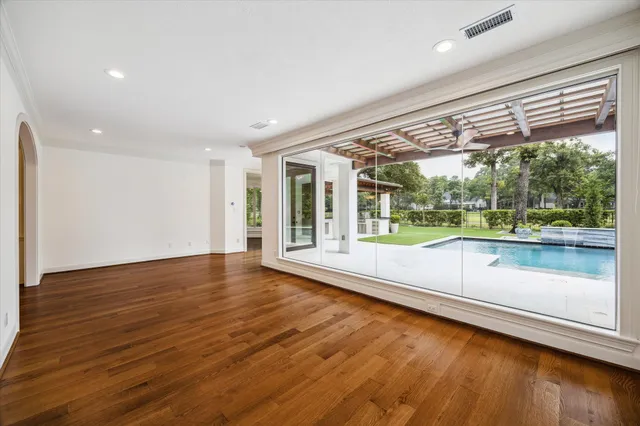 wooden floor in an empty room with a large window