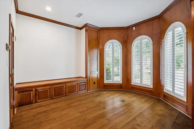 a view of a livingroom with wooden floor and a large window