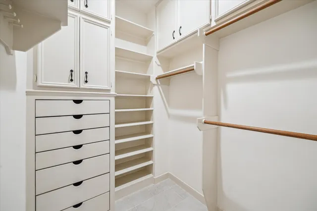 a view of walk in closet with empty racks