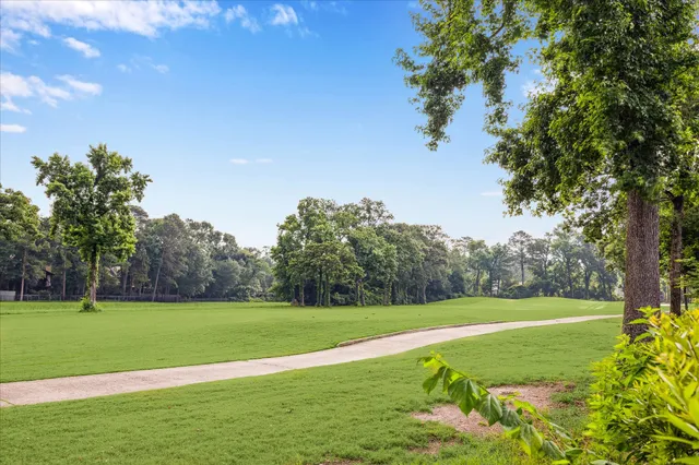 a view of a backyard with table and chairs under an umbrella