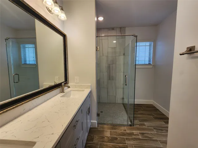 a bathroom with a shower and a sink