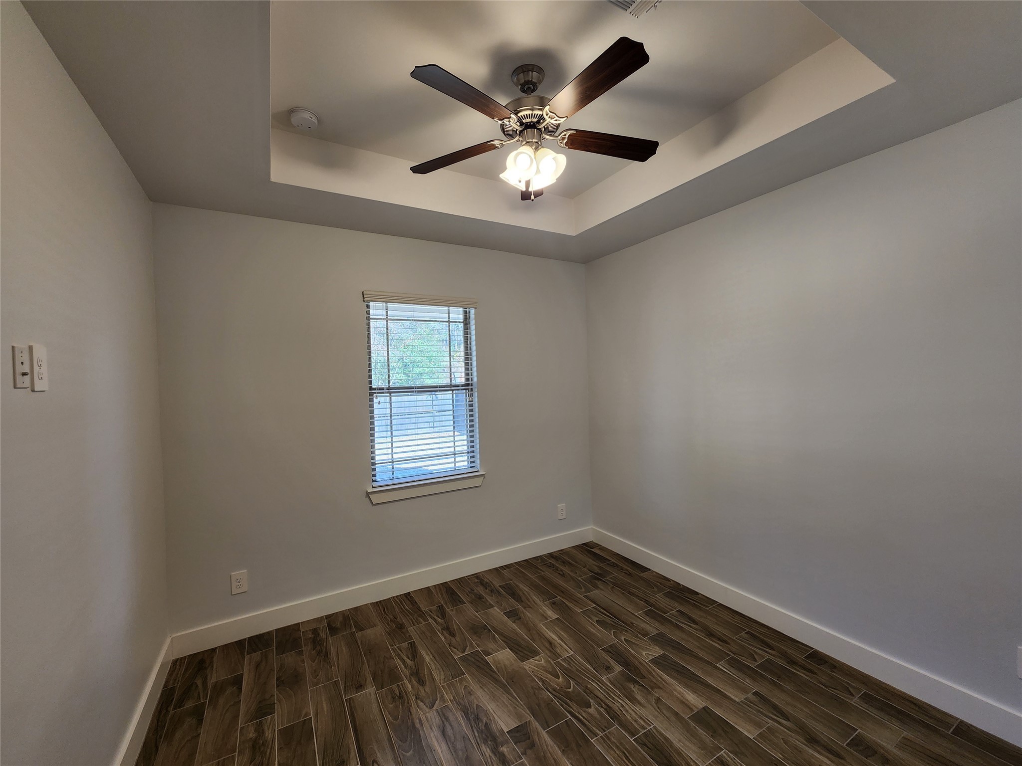 25982 Lantern Lane New Caney, TX 77357 - Photo 6 of 26 an empty room with wooden floor and ceiling fan