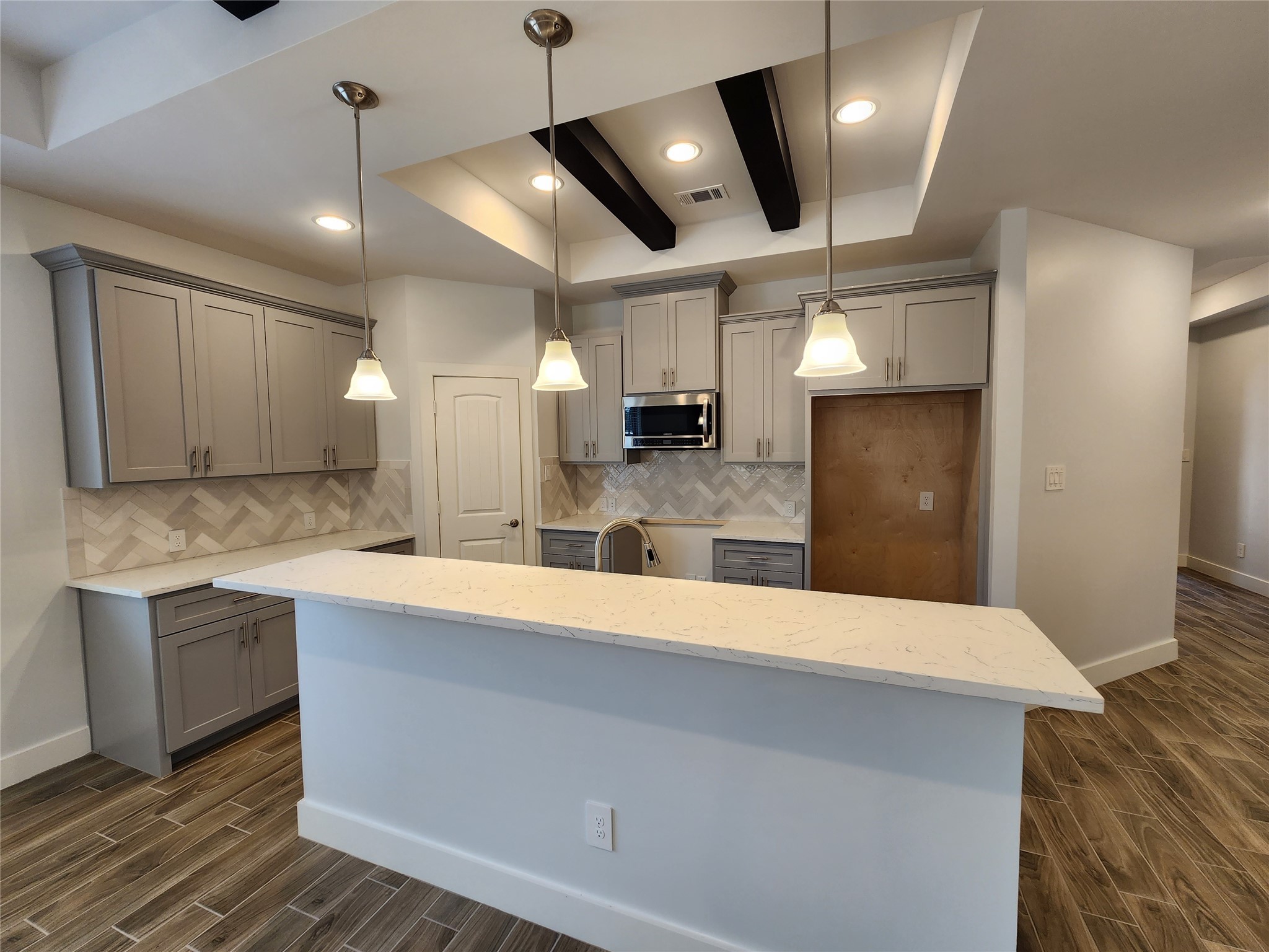 25982 Lantern Lane New Caney, TX 77357 - Photo 7 of 26 a large kitchen with stainless steel appliances a large counter top