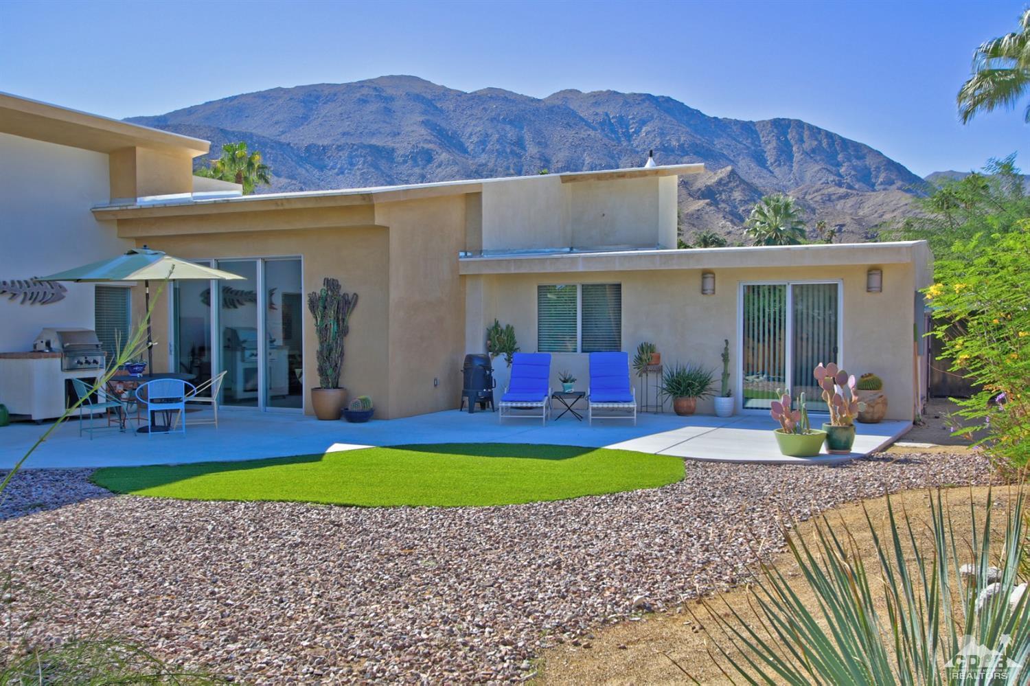 71728 Tunis Road Rancho Mirage, CA 92270 - Photo 3 of 44 a view of a house with a swimming pool and a yard