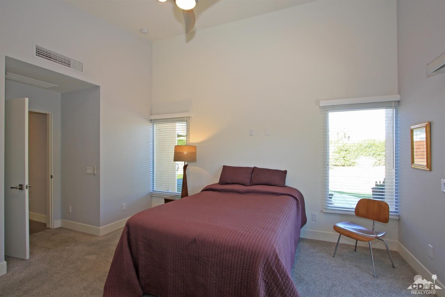 71728 Tunis Road Rancho Mirage, CA 92270 - Photo 21 of 44 a bedroom with a bed and a window