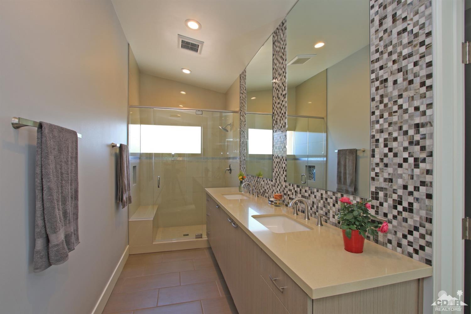 71728 Tunis Road Rancho Mirage, CA 92270 - Photo 22 of 44 a bathroom with a shower sink and mirror