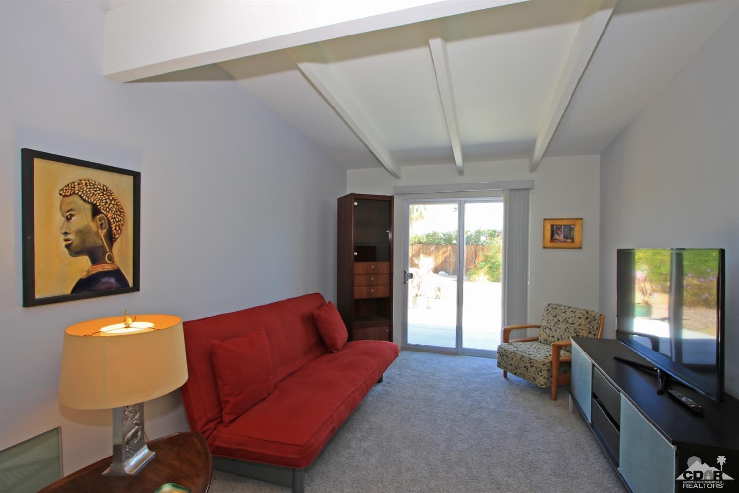 71728 Tunis Road Rancho Mirage, CA 92270 - Photo 25 of 44 a living room with furniture and a flat screen tv