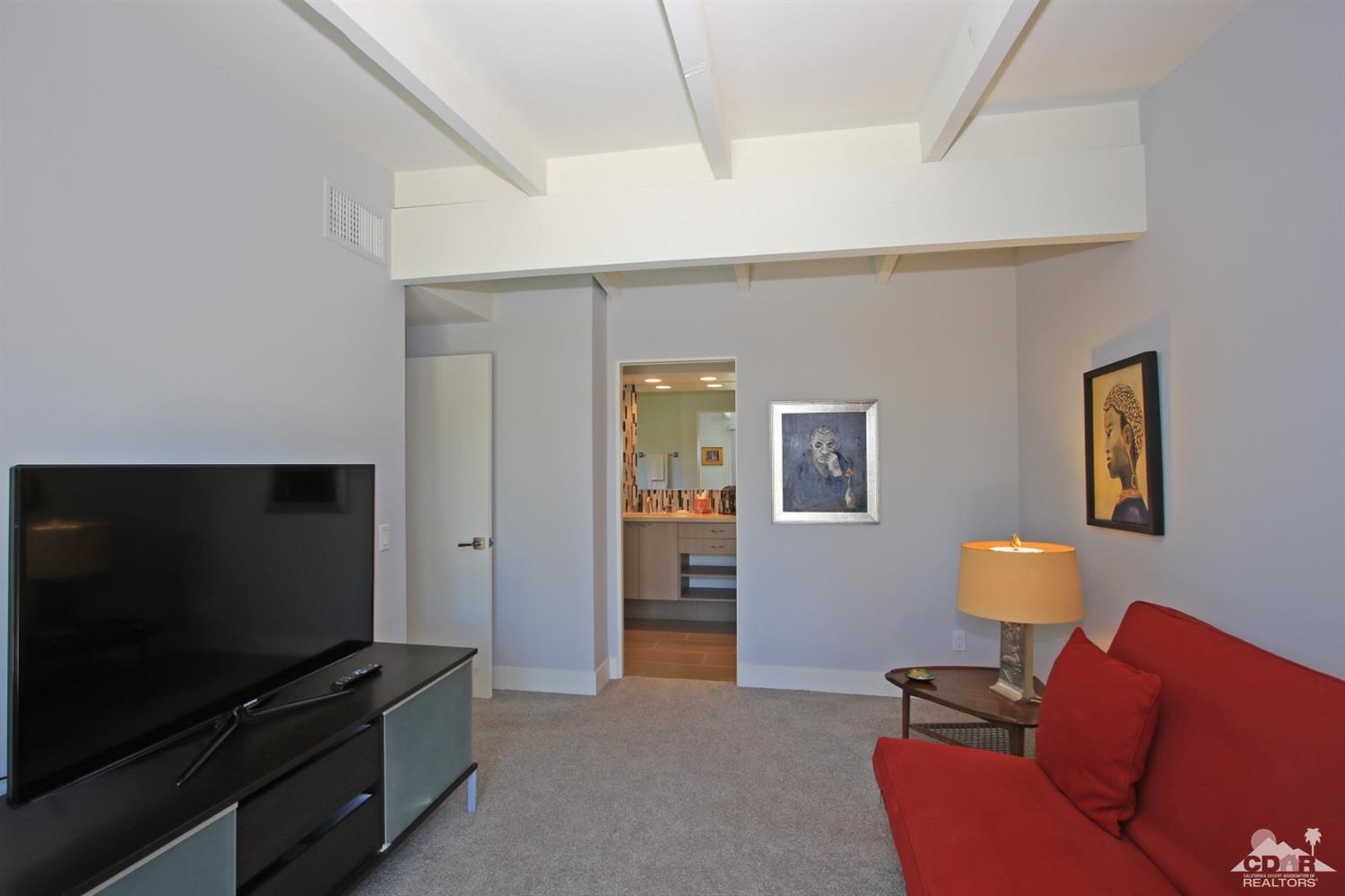 71728 Tunis Road Rancho Mirage, CA 92270 - Photo 26 of 44 a living room with furniture and a flat screen tv
