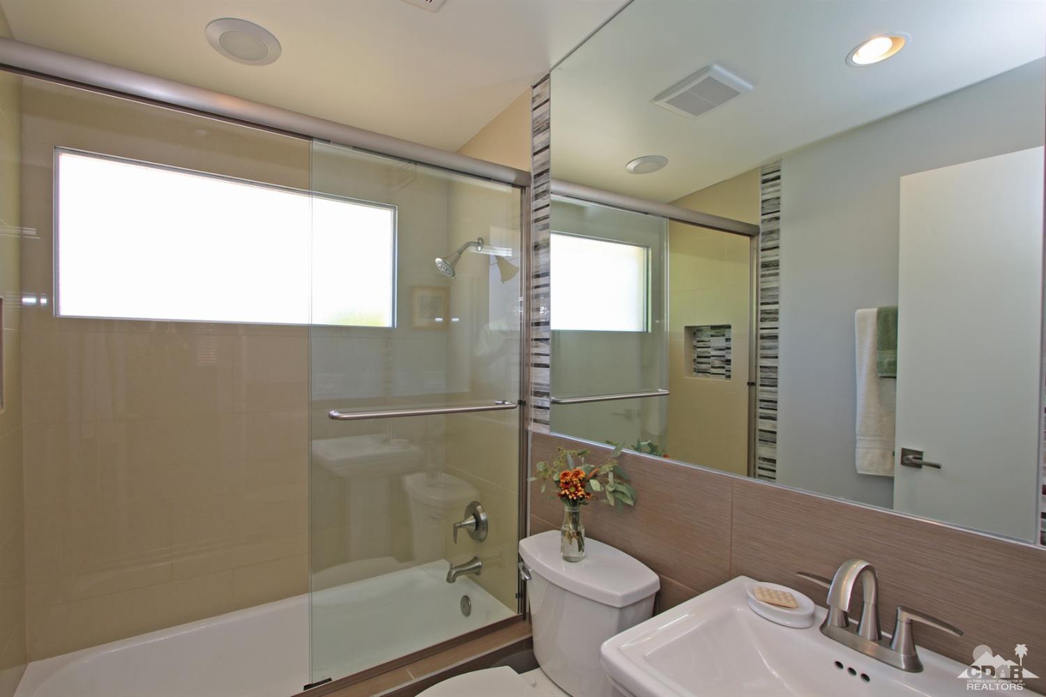 71728 Tunis Road Rancho Mirage, CA 92270 - Photo 30 of 44 a bathroom with a sink mirror bathtub and toilet