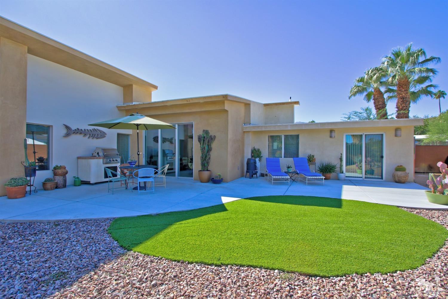 71728 Tunis Road Rancho Mirage, CA 92270 - Photo 33 of 44 a view of a house with a patio and swimming pool