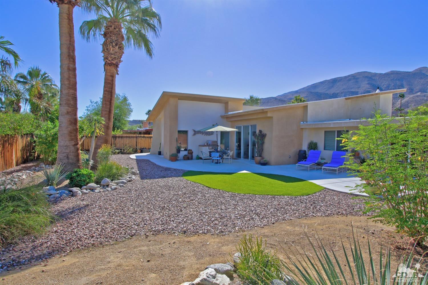 71728 Tunis Road Rancho Mirage, CA 92270 - Photo 34 of 44 a view of a house with a yard and table and chairs under an umbrella