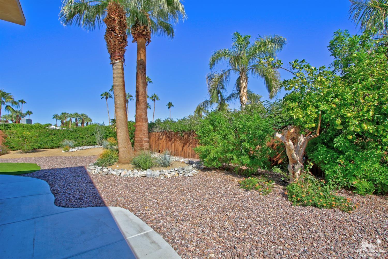 71728 Tunis Road Rancho Mirage, CA 92270 - Photo 39 of 44 a front view of a house with a yard and potted plants