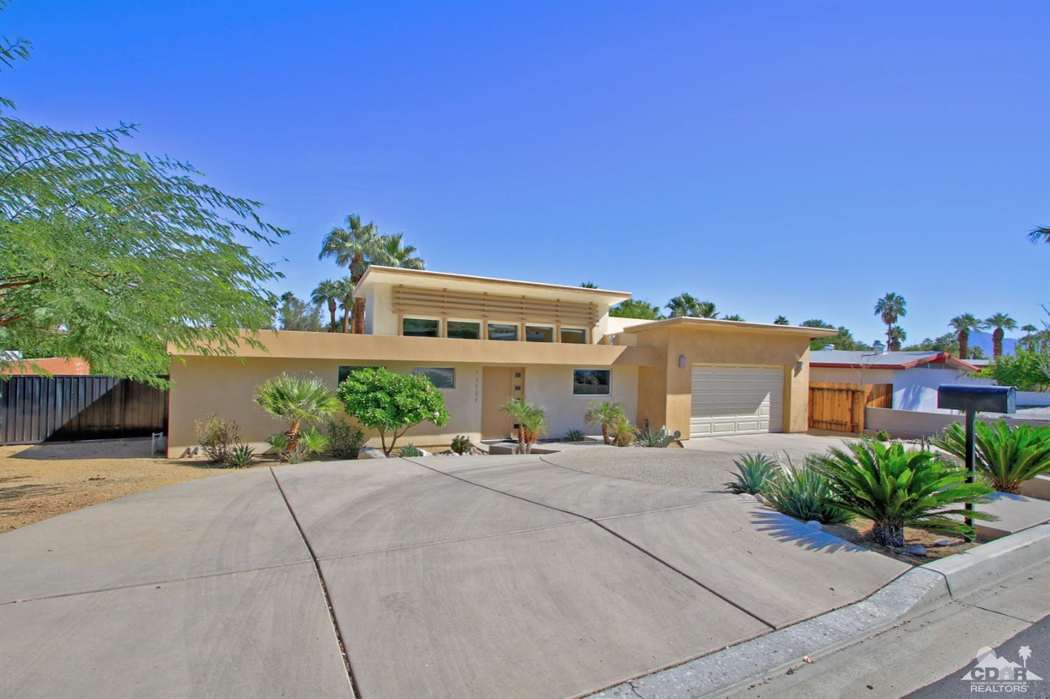 71728 Tunis Road Rancho Mirage, CA 92270 - Photo 6 of 44 a front view of a house with a garden