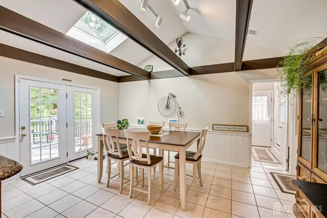a dining hall with stainless steel appliances granite countertop a stove and cabinets