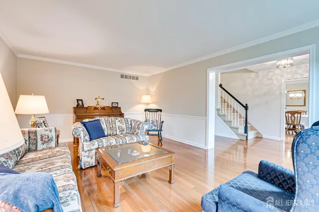 a dining room with furniture potted plants and wooden floor