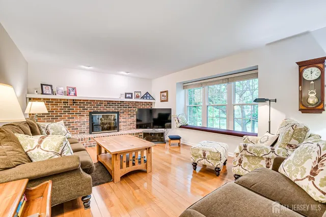 a view of a livingroom with wooden floor and stairs