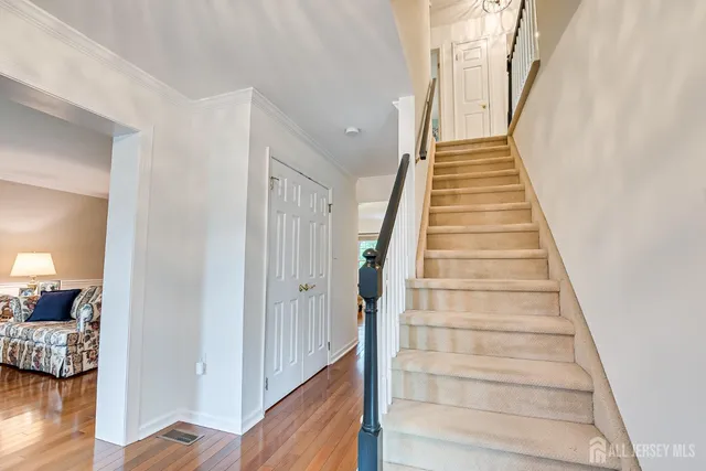 a bathroom with double vanity sink a two mirror a window and a shower