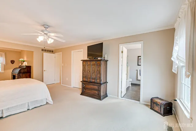 a bedroom with two beds and a chandelier