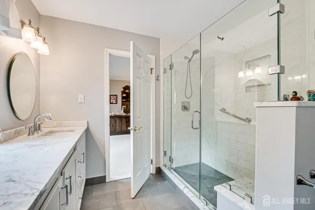 a bathroom with a double vanity sink toilet and shower