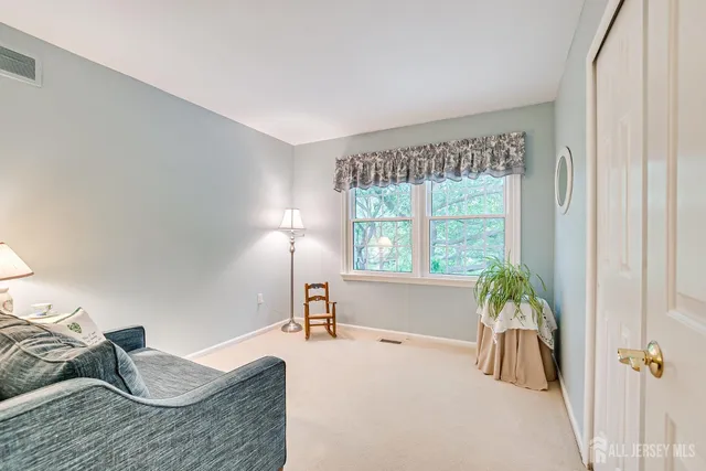 a view of a house with a big yard and large trees