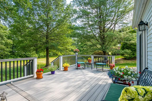 an aerial view of a houses with a yard and lake view