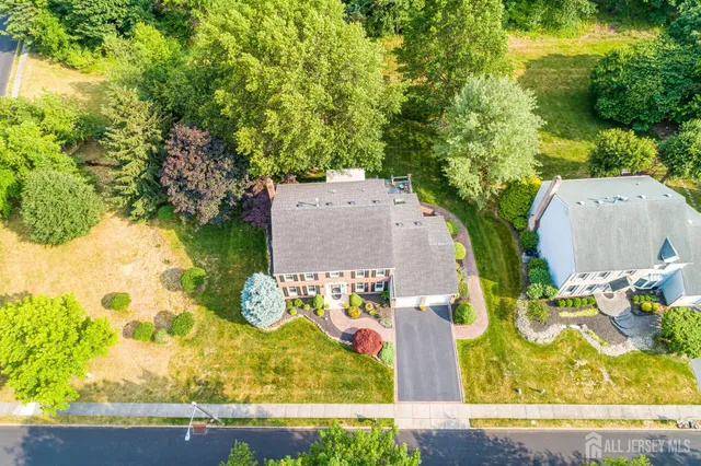 an aerial view of a house with a yard and ocean view