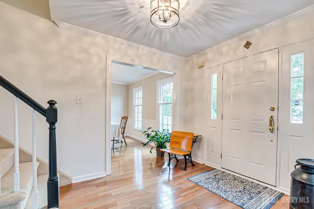 a kitchen with stainless steel appliances granite countertop a refrigerator a sink a stove and island with wooden floor