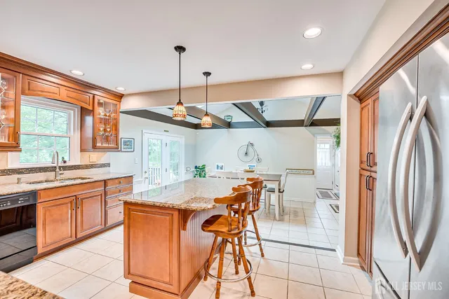 a kitchen with stainless steel appliances granite countertop a sink stove and cabinets