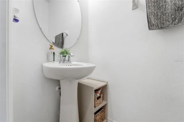 a bathroom with a sink a mirror and vanity