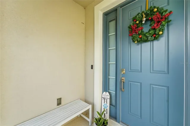 a view of a hallway with wooden floor and a potted plant