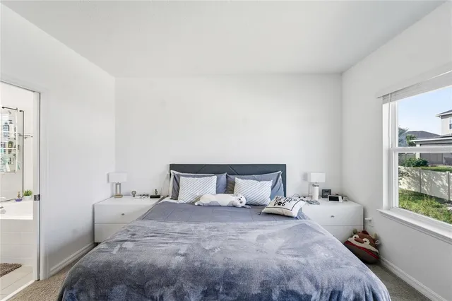 a bedroom with a bed and window