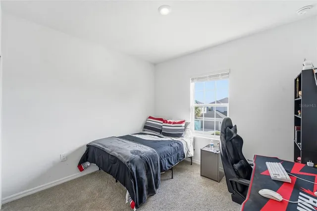 a room with a bed furniture and a window