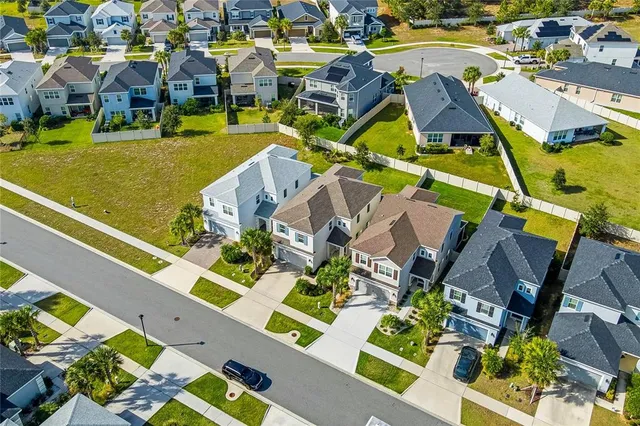 an aerial view of residential houses with yard