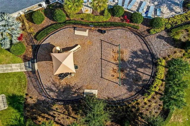 an aerial view of a house with a yard and a fountain