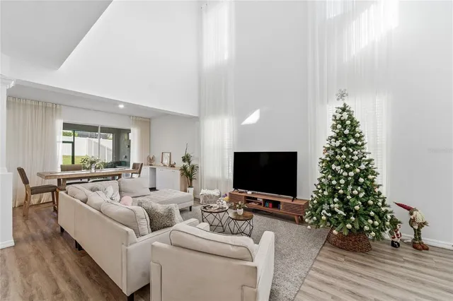 a living room with furniture a window and a flat screen tv