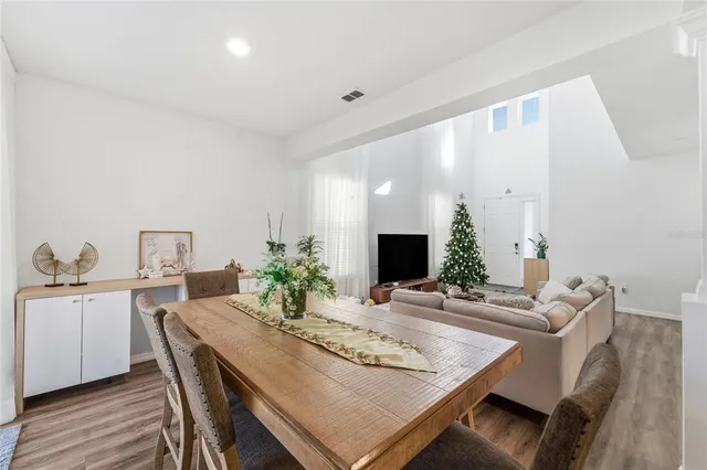a view of a dining room with furniture and wooden floor