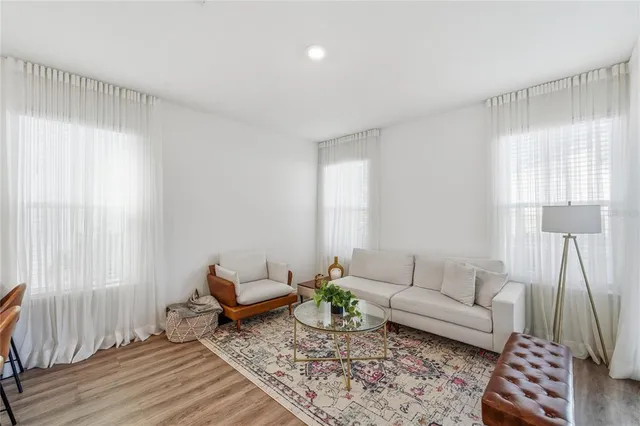 a living room with furniture and wooden floor