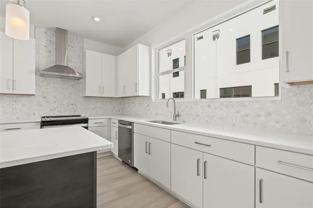 a kitchen with granite countertop white cabinets stainless steel appliances and sink