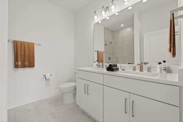 a bathroom with a sink a toilet and a shower