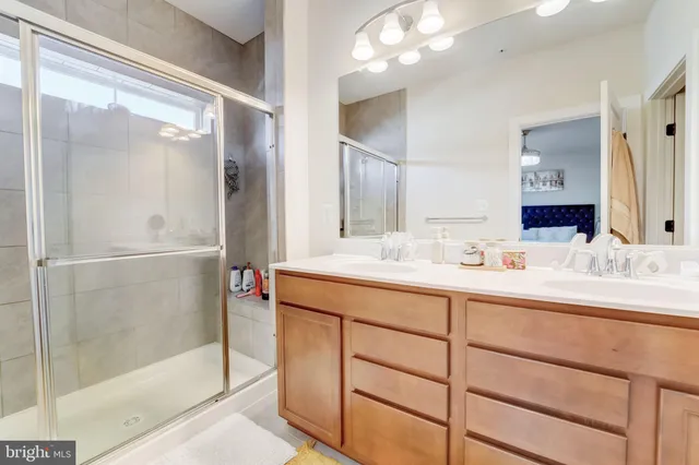 a bathroom with a shower sink and mirror