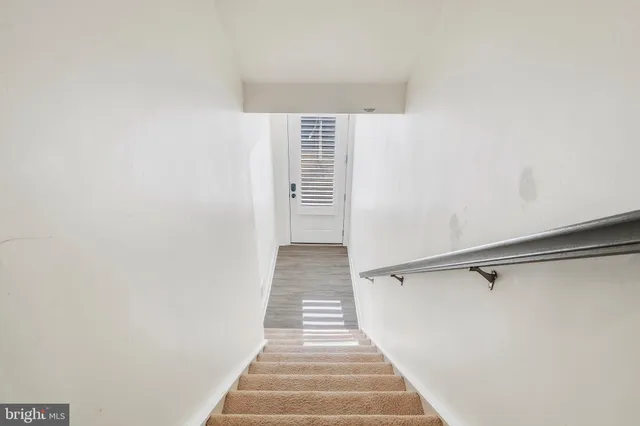 a view of a hallway with stairs