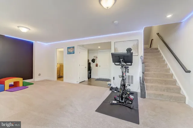 a view of a livingroom with furniture and stairs