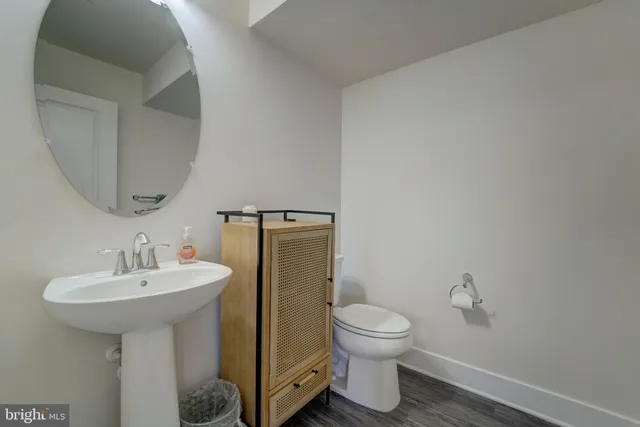 a bathroom with a toilet sink and mirror