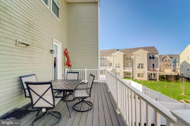 a view of a balcony with two chairs and a table