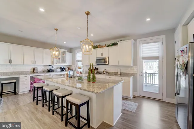 a large kitchen with a table and chairs